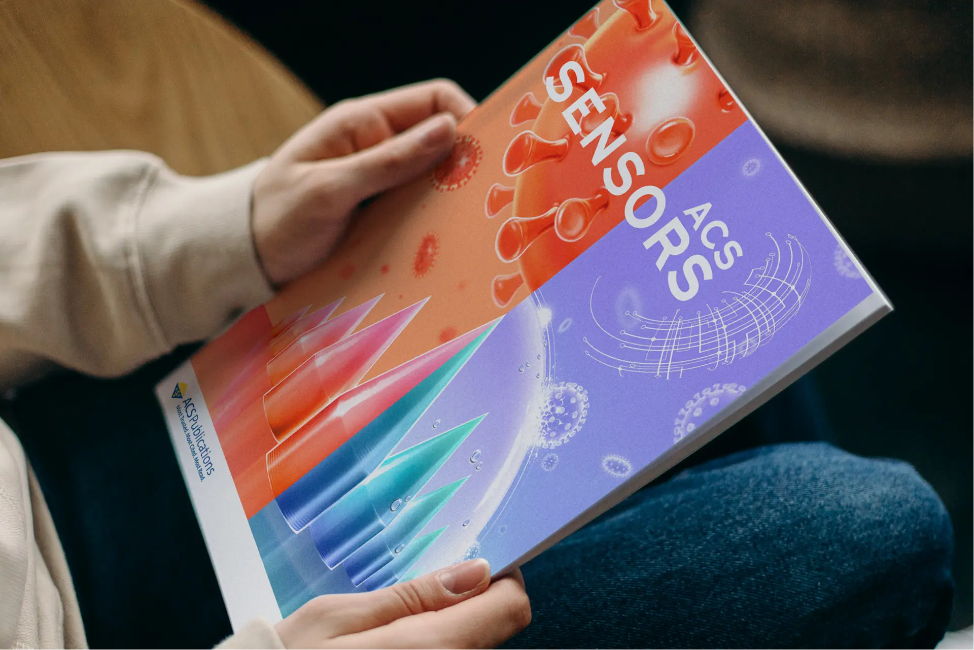 Revista científica impresa sostenida en la mano, material visual de un proyecto